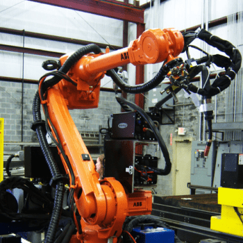 Orange robotic welding arm in workshop