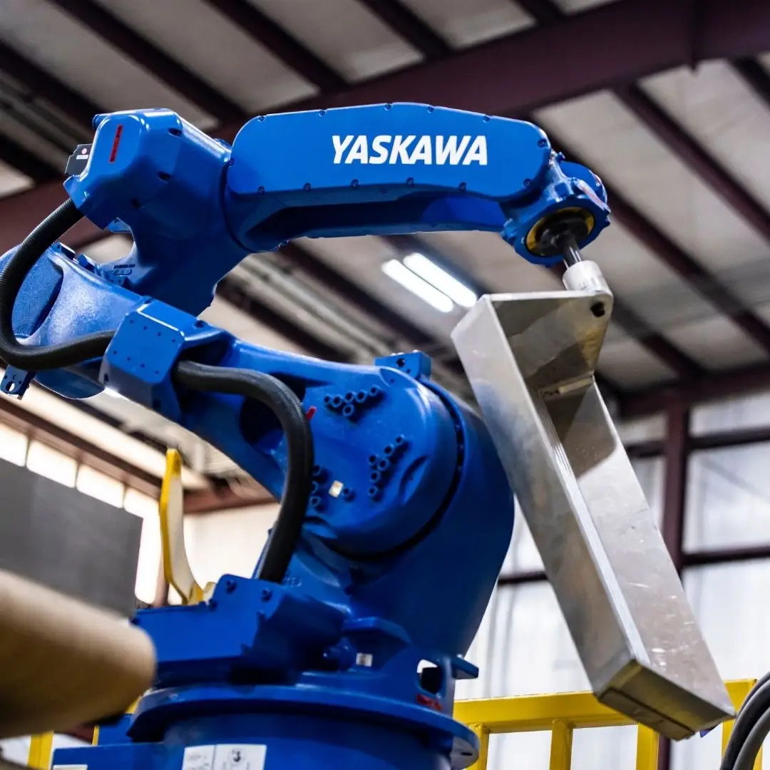 Industrial robotic arm in a warehouse setting.