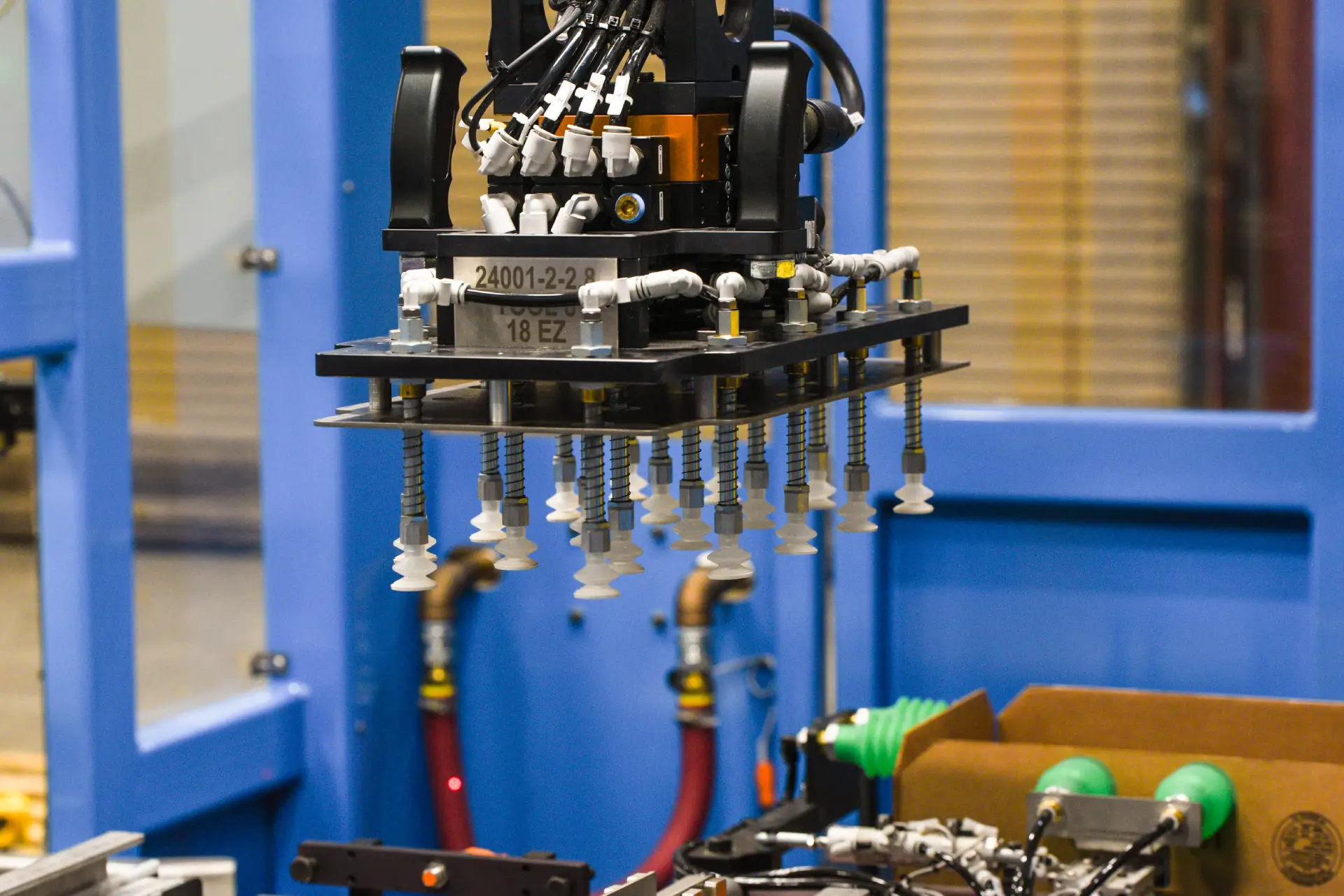 Robotic arm assembling components in factory.