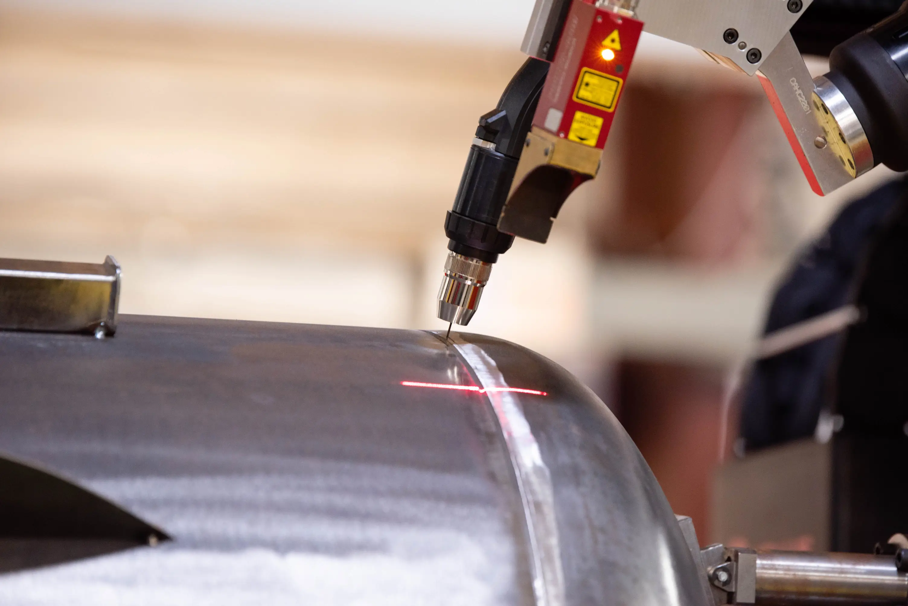 Laser-guided welding torch on metal seam