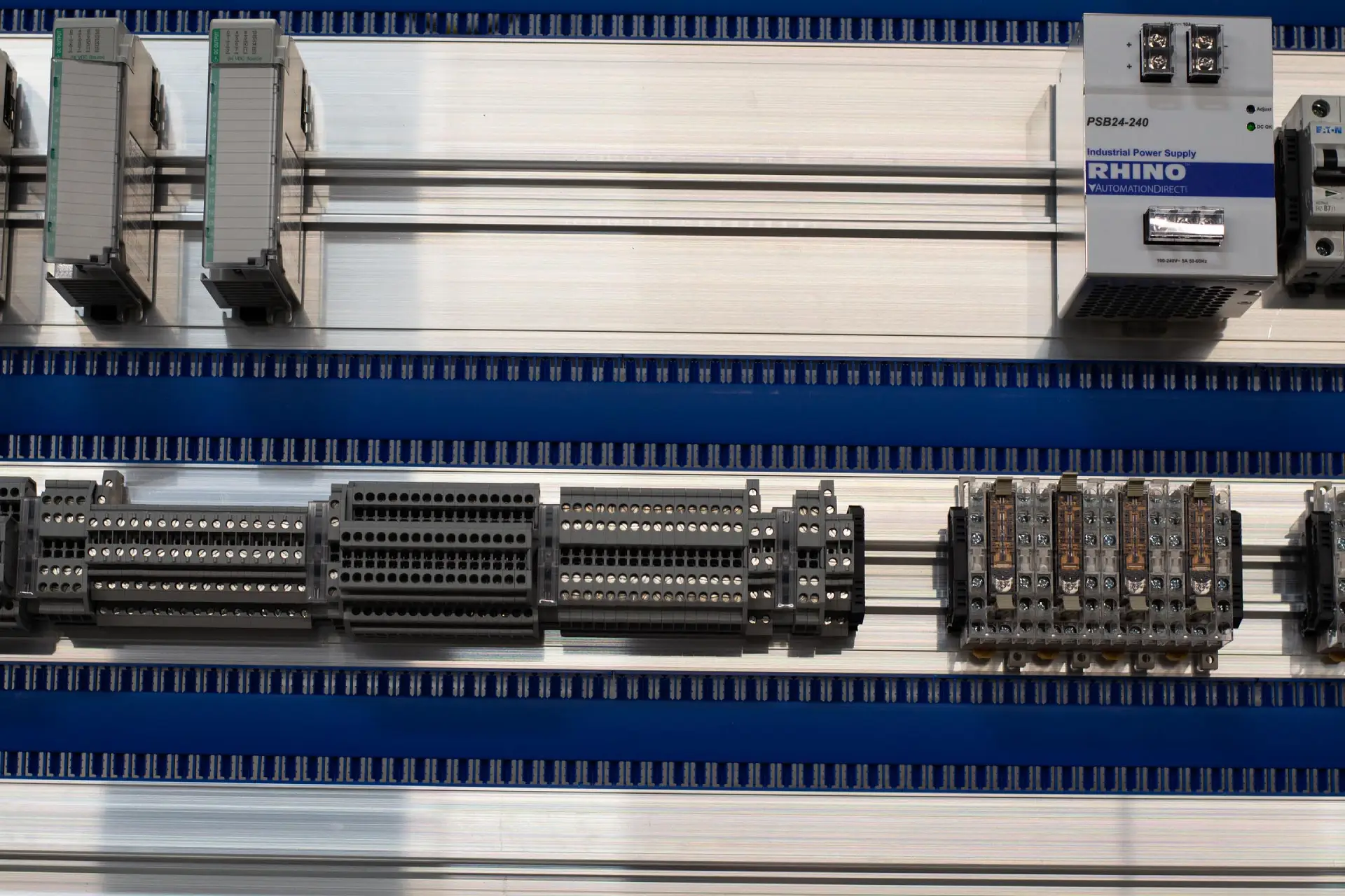 Electrical components on a metal mounting rail.