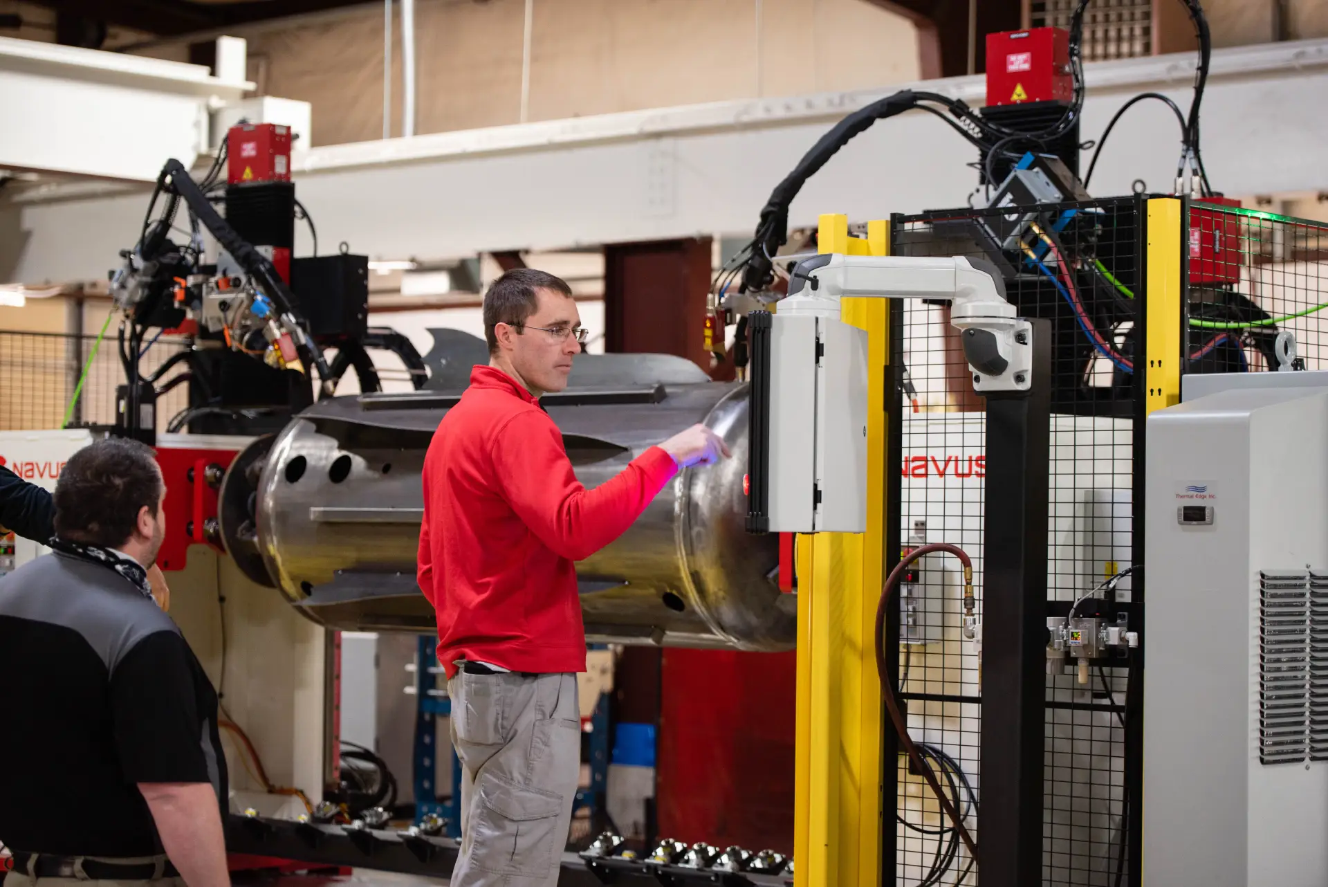 Technicians working on industrial machinery setup.
