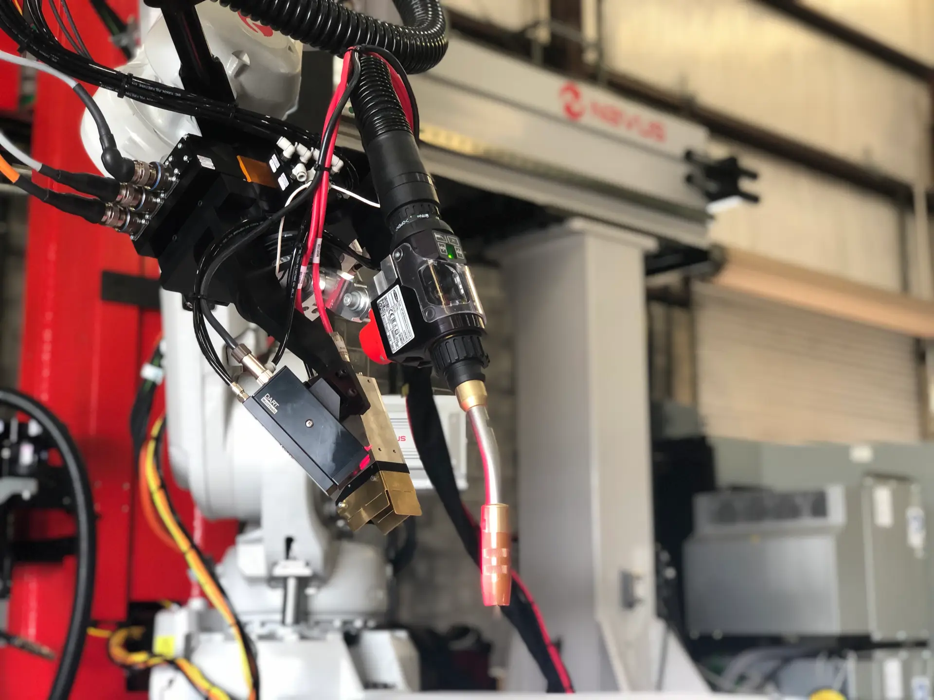 Robotic arm with wires and tools attached.
